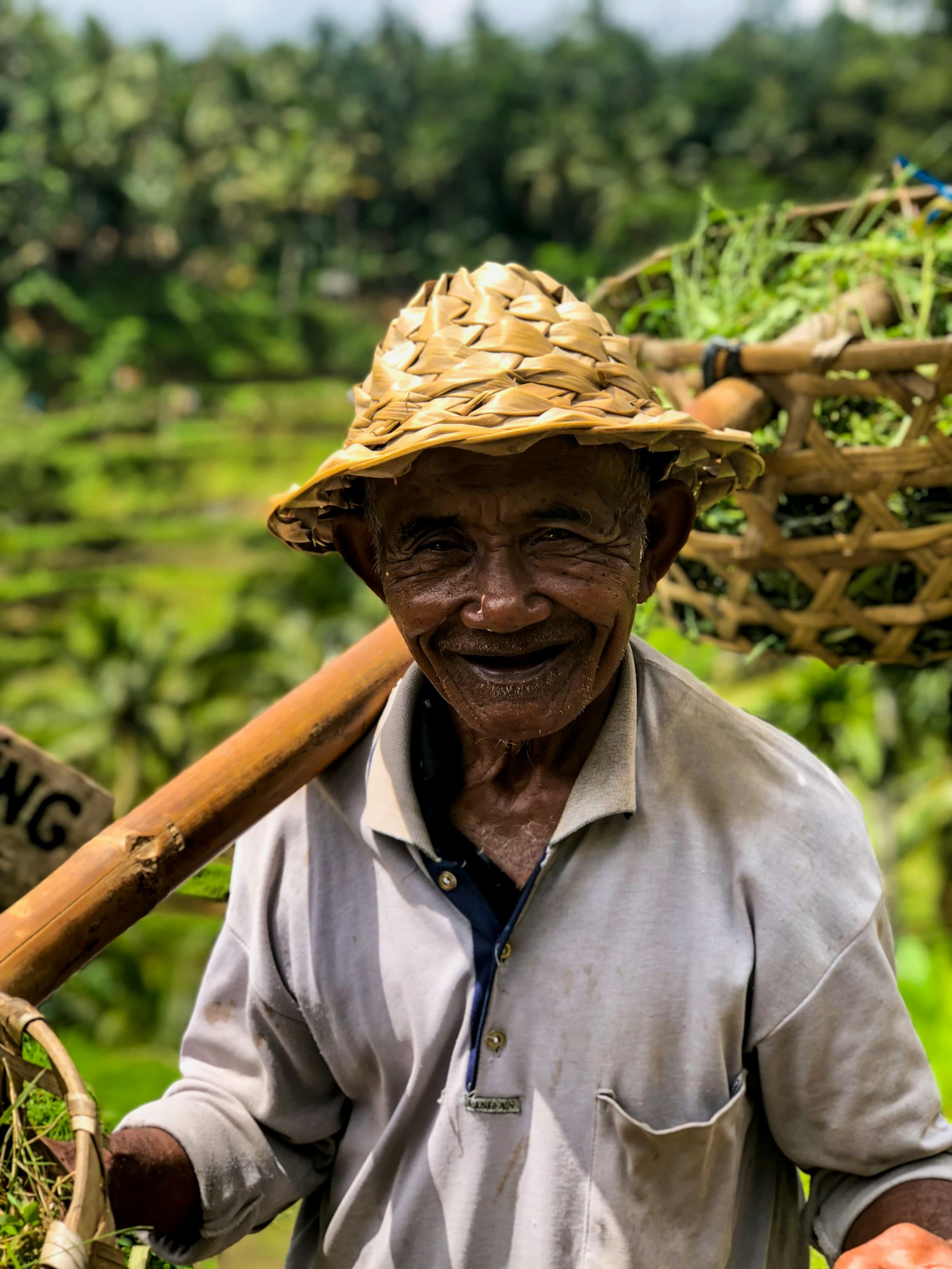 A smiling farmer in a straw hat