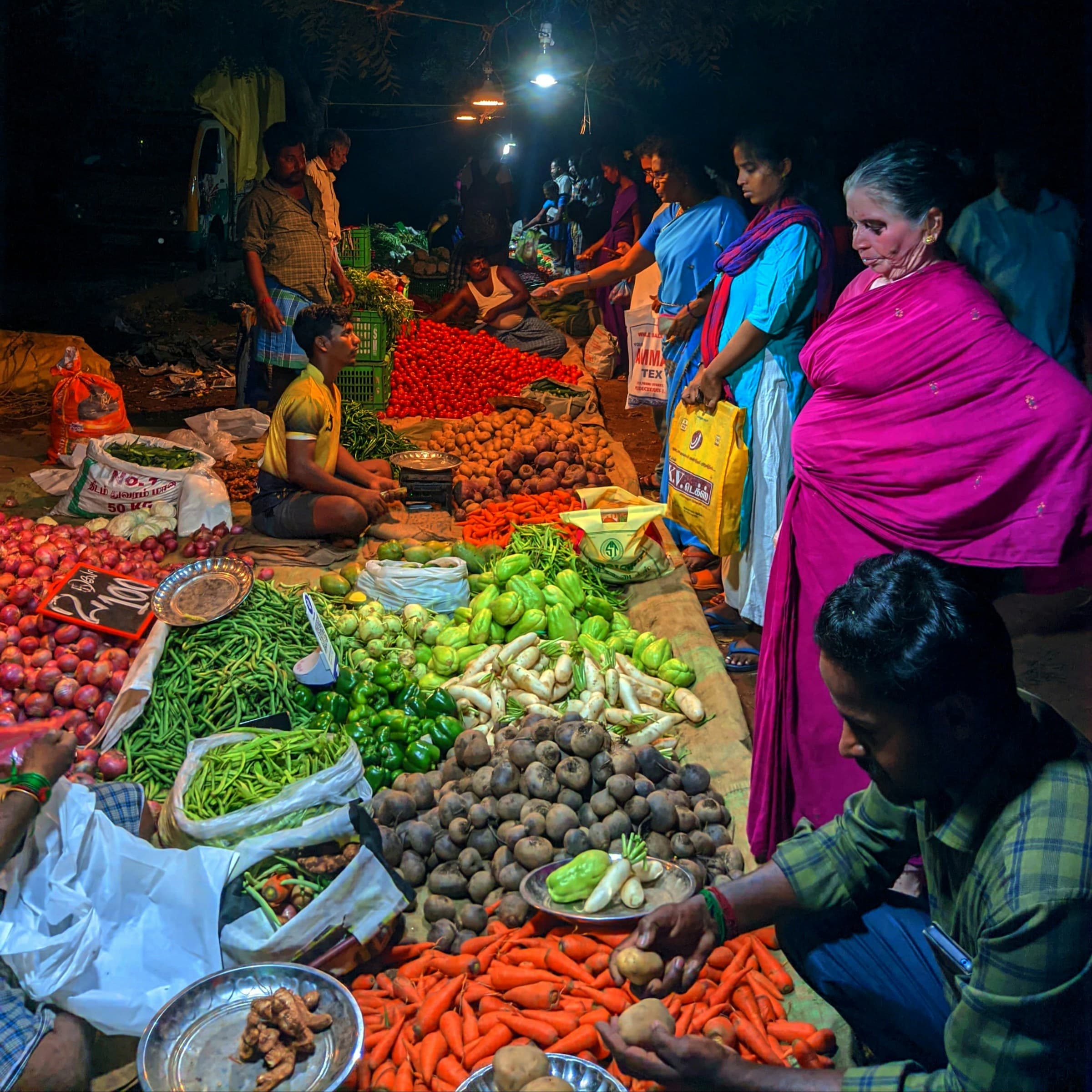 A busy traditional Indian vegetable market piled with fresh produce