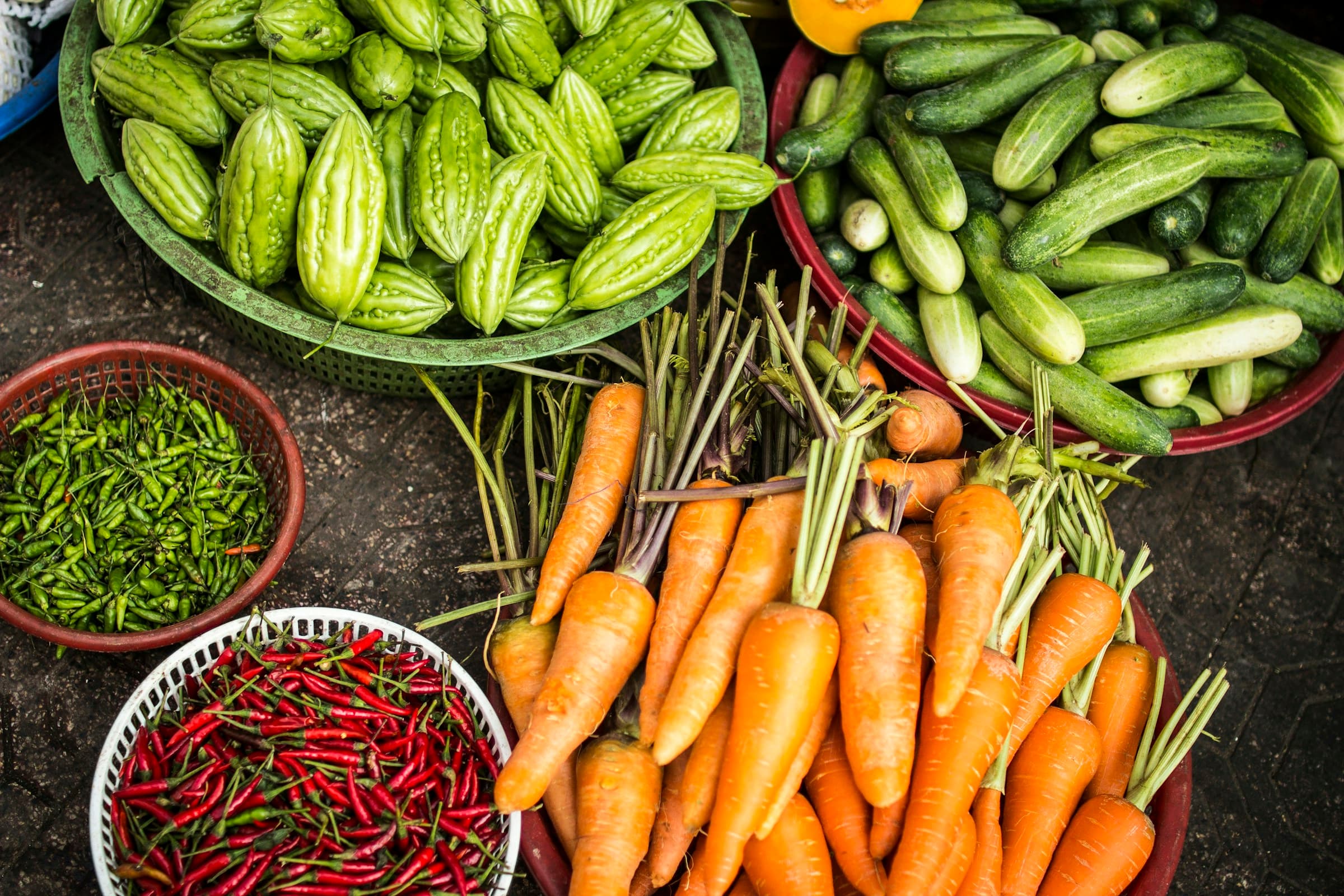 Fresh carrots, okra, chillies and beans laid out together